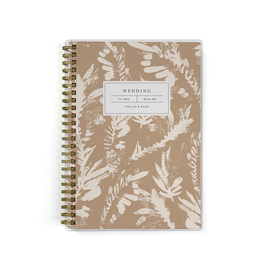 Our inclusive gender-neutral LGBT Mini Wedding Planners are perfect for planning a small wedding or elopement, shown in a neutral boho leaf print