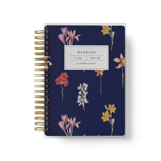 Shown in a dark botanical floral design, our exclusive LGBT wedding planner books are all-inclusive and gender-neutral