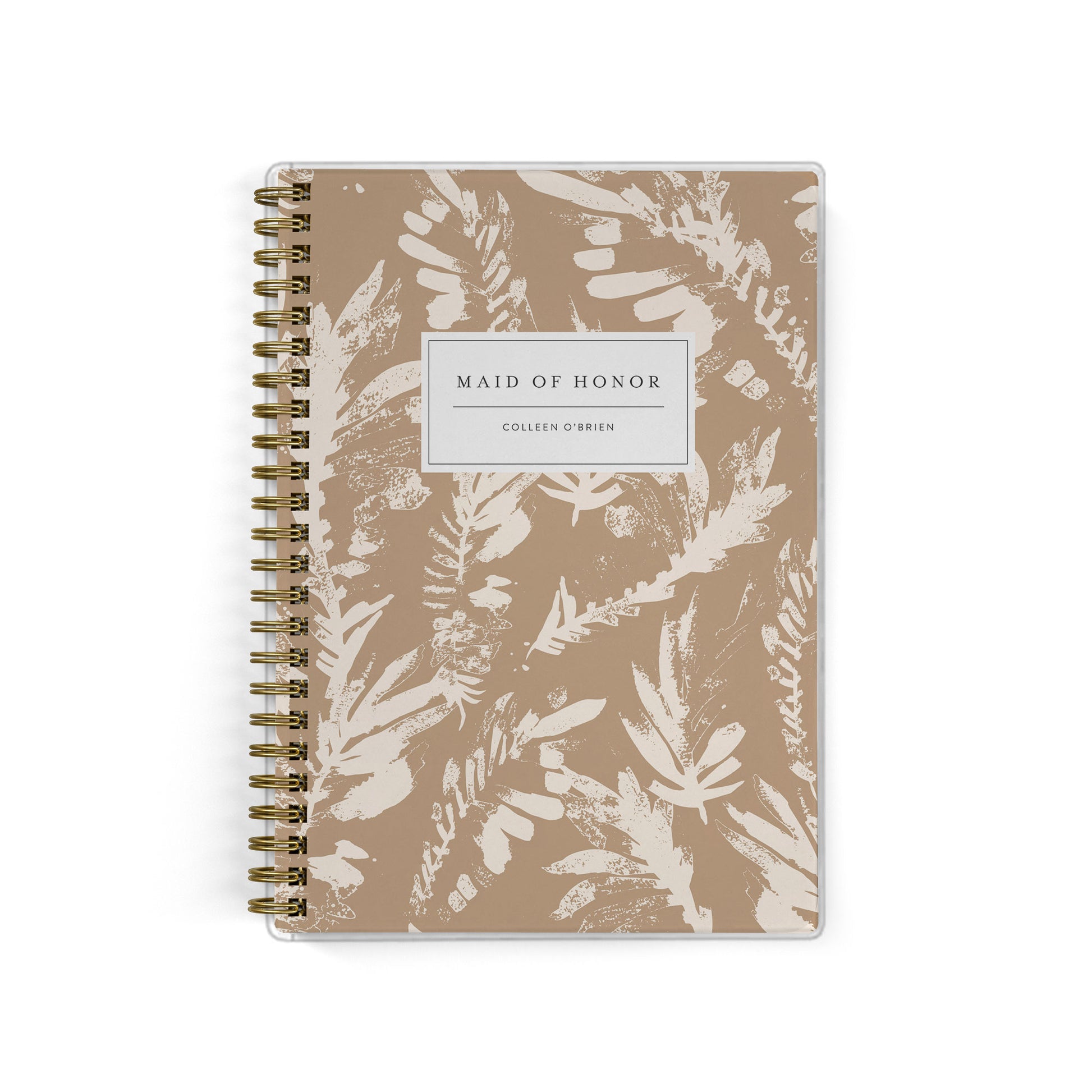 Our exclusive maid of honor planners are the perfect gift for your best friend, shown in a neutral boho leaf print