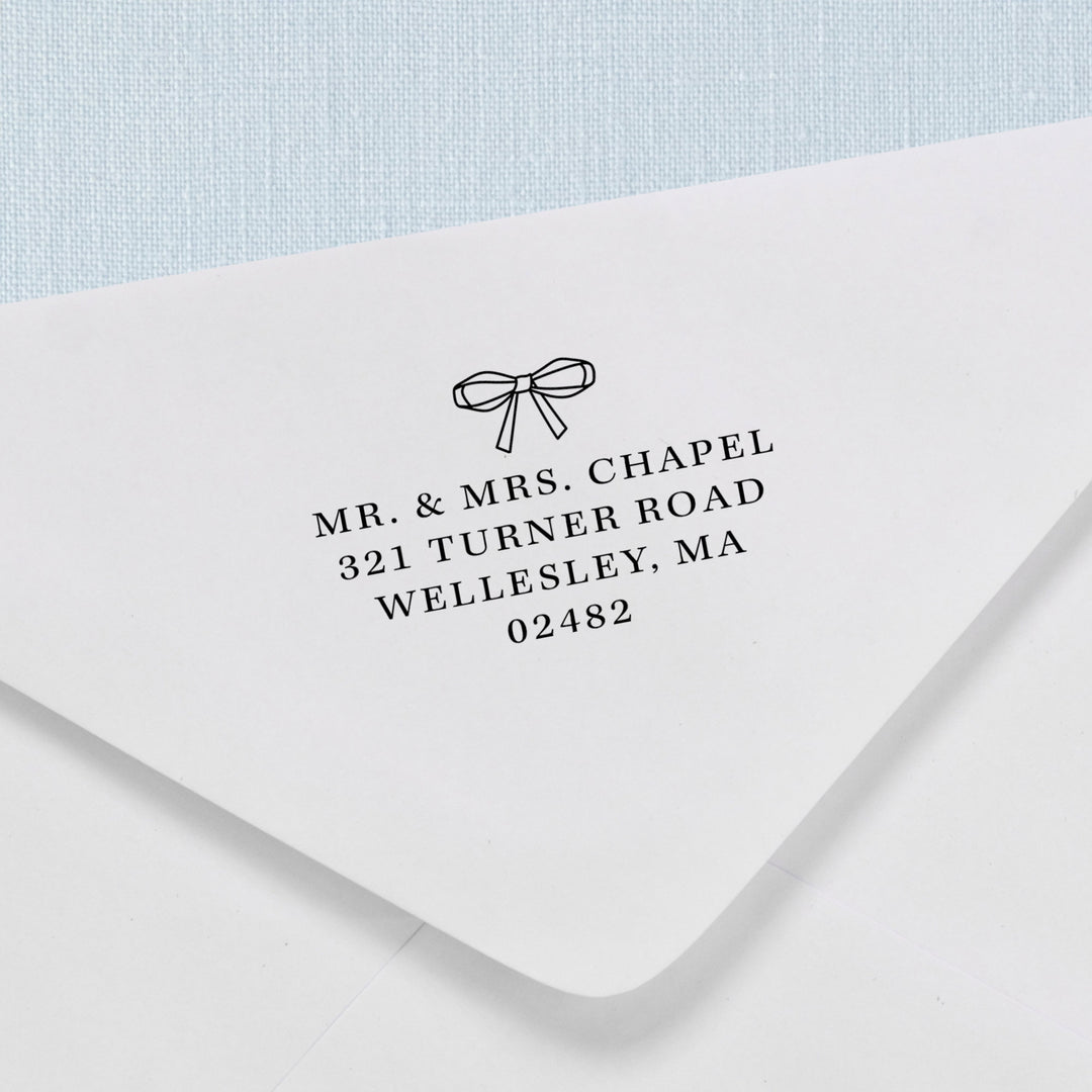 Custom return address stamp in a delicate ribbon bow design