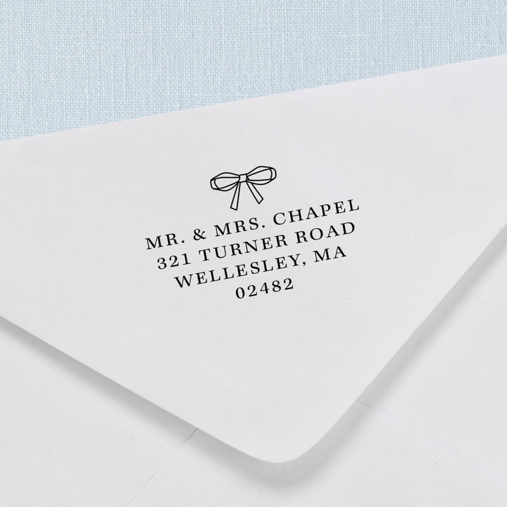 Custom return address stamp in a delicate ribbon bow design