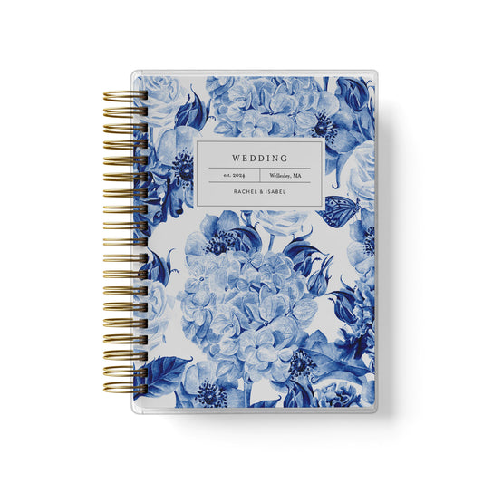 Shown in a blue toile hydrangea design, our exclusive LGBT wedding planner books are all-inclusive and gender-neutral