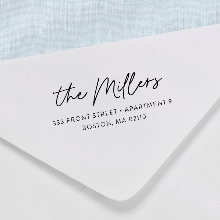 Custom return address stamp in a modern calligraphy script design