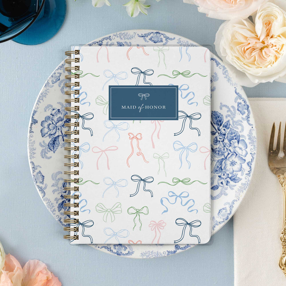 Our exclusive maid of honor planners are the perfect gift for your best friend, shown in a delicate bow design.