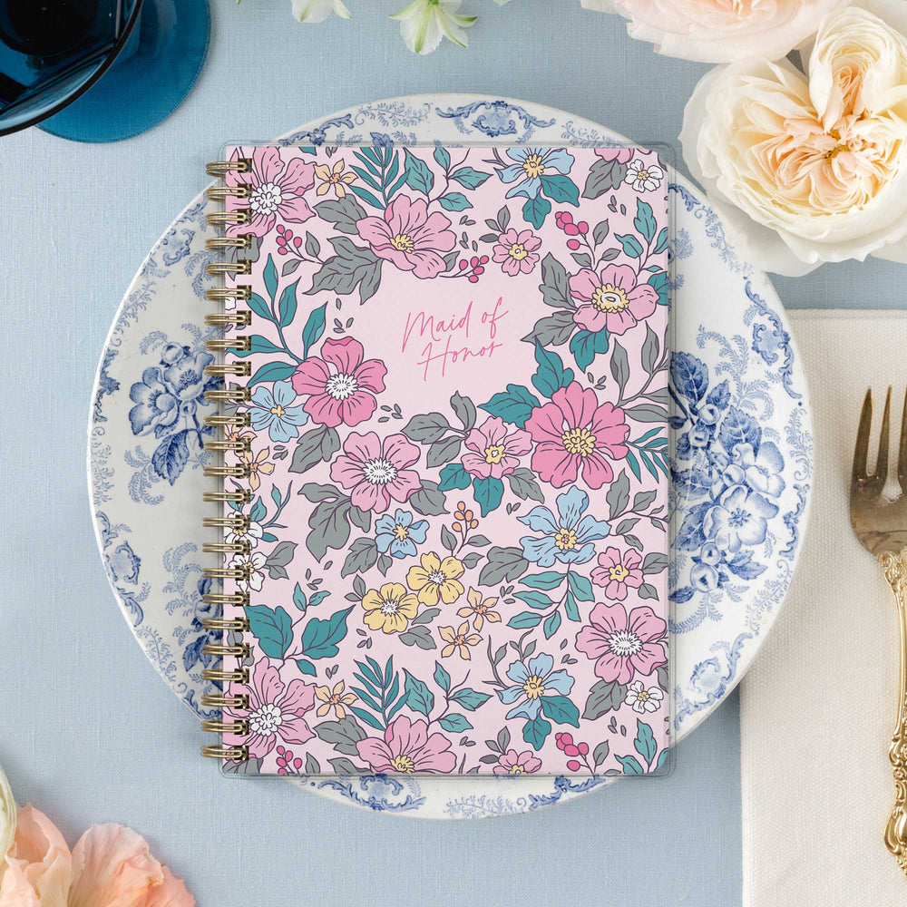 Our exclusive maid of honor planners are the perfect gift for your best friend, shown in a colorful garden floral design.